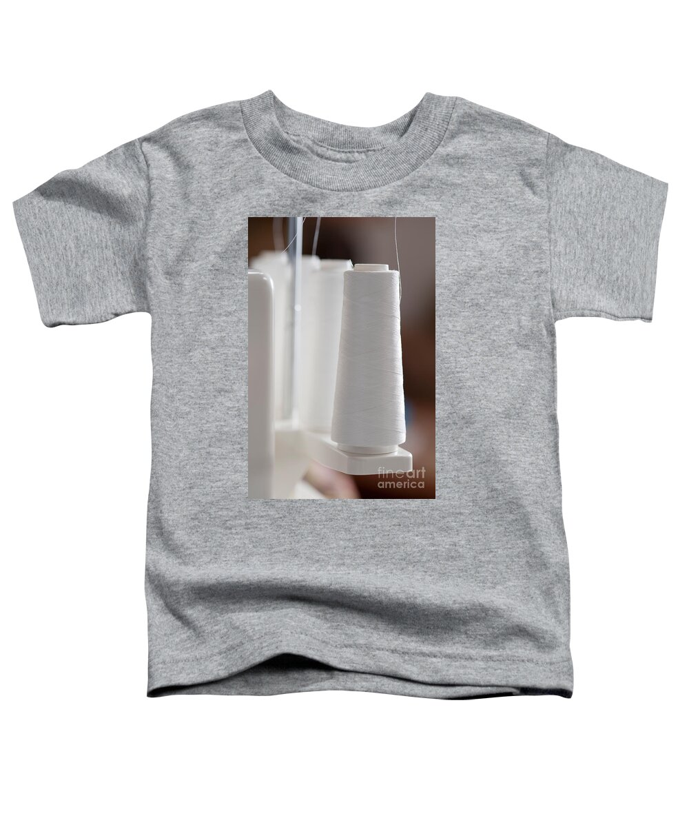 Apparel Toddler T-Shirt featuring the photograph Spools Of White Thread On Serger by Jim Corwin