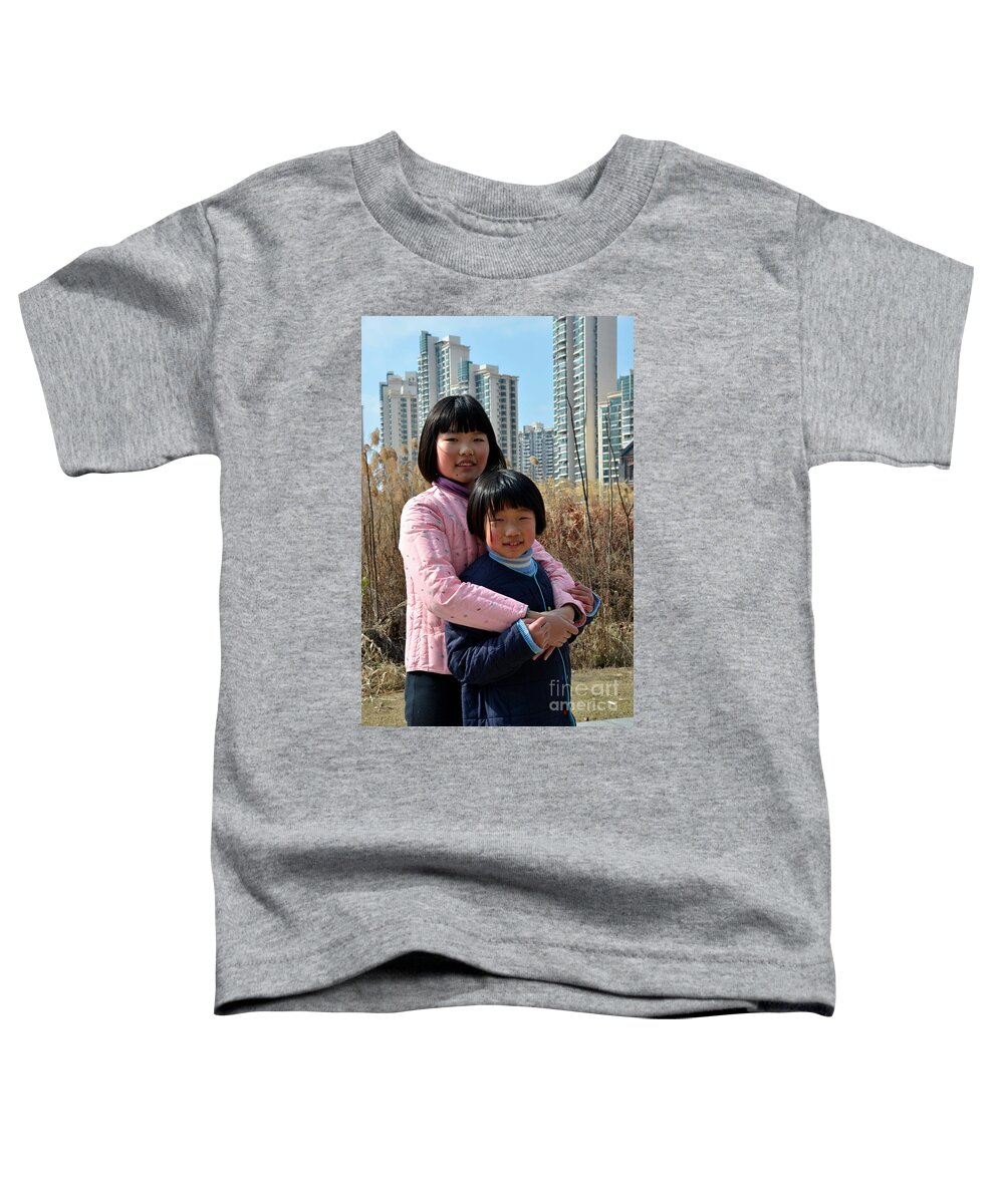 Girls Toddler T-Shirt featuring the photograph Two Chinese teen sisters hug and embrace Shanghai China by Imran Ahmed