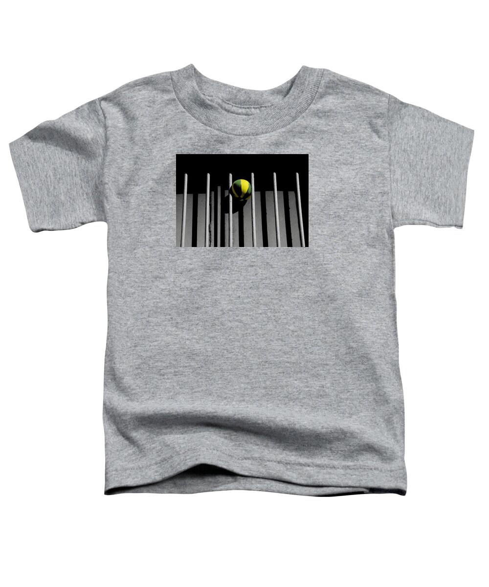 Ball Toddler T-Shirt featuring the photograph Ball between bars by Emme Pons