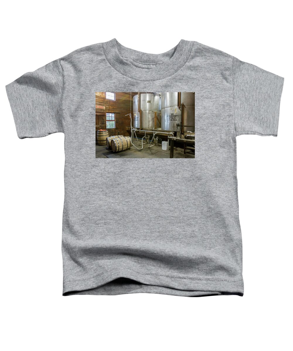 American Toddler T-Shirt featuring the photograph Inside barrel filling room of distillery by Karen Foley