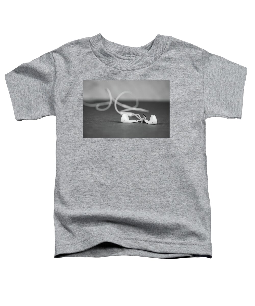 Concept Toddler T-Shirt featuring the photograph Miniature Figure listening to Music and Sitting on Earbuds by Tammy Ray
