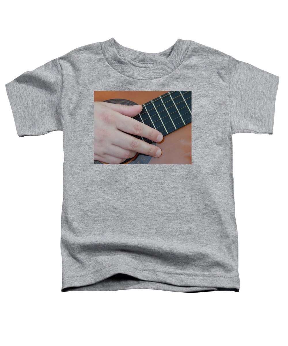 Guitar Toddler T-Shirt featuring the photograph Playing hands on guitar music by Oleg Prokopenko