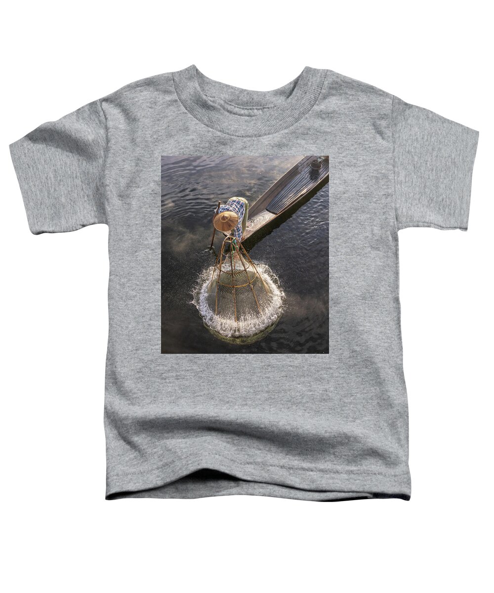Fisherman Toddler T-Shirt featuring the photograph traditional Intha fisherman in long boat in the early morning on Lake Inle by Ann Moore