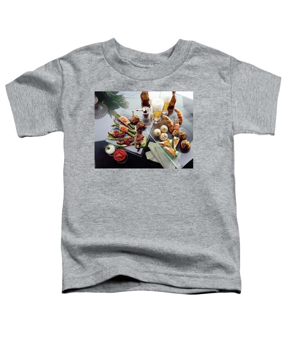 Ip_10190301 Toddler T-Shirt featuring the photograph Various Party Snacks On Glass Plates by Jalag / Walter Cimbal