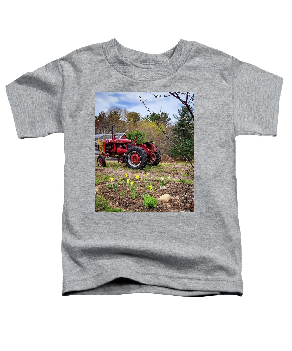 Mccormick Toddler T-Shirt featuring the photograph Tractor and Daffodils by Mary Capriole