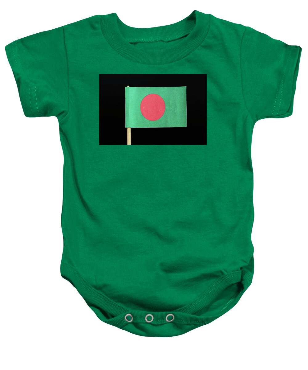  Bangladesh Baby Onesie featuring the photograph The national flag of Bangladesh on toothpick on black background. A red disc on a green field by Vaclav Sonnek