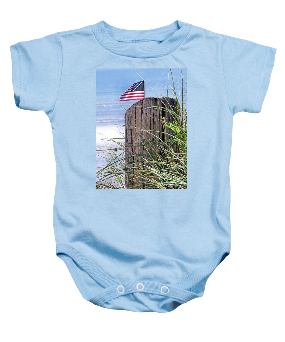 American Flag Baby Onesie featuring the photograph Banner Yet Wave at Beach by Janice Drew