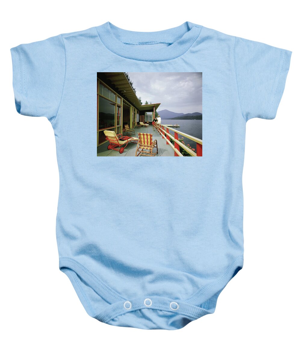 Alfred Rose Baby Onesie featuring the photograph Two Women On The Deck Of A House On A Lake by Robert M. Damora