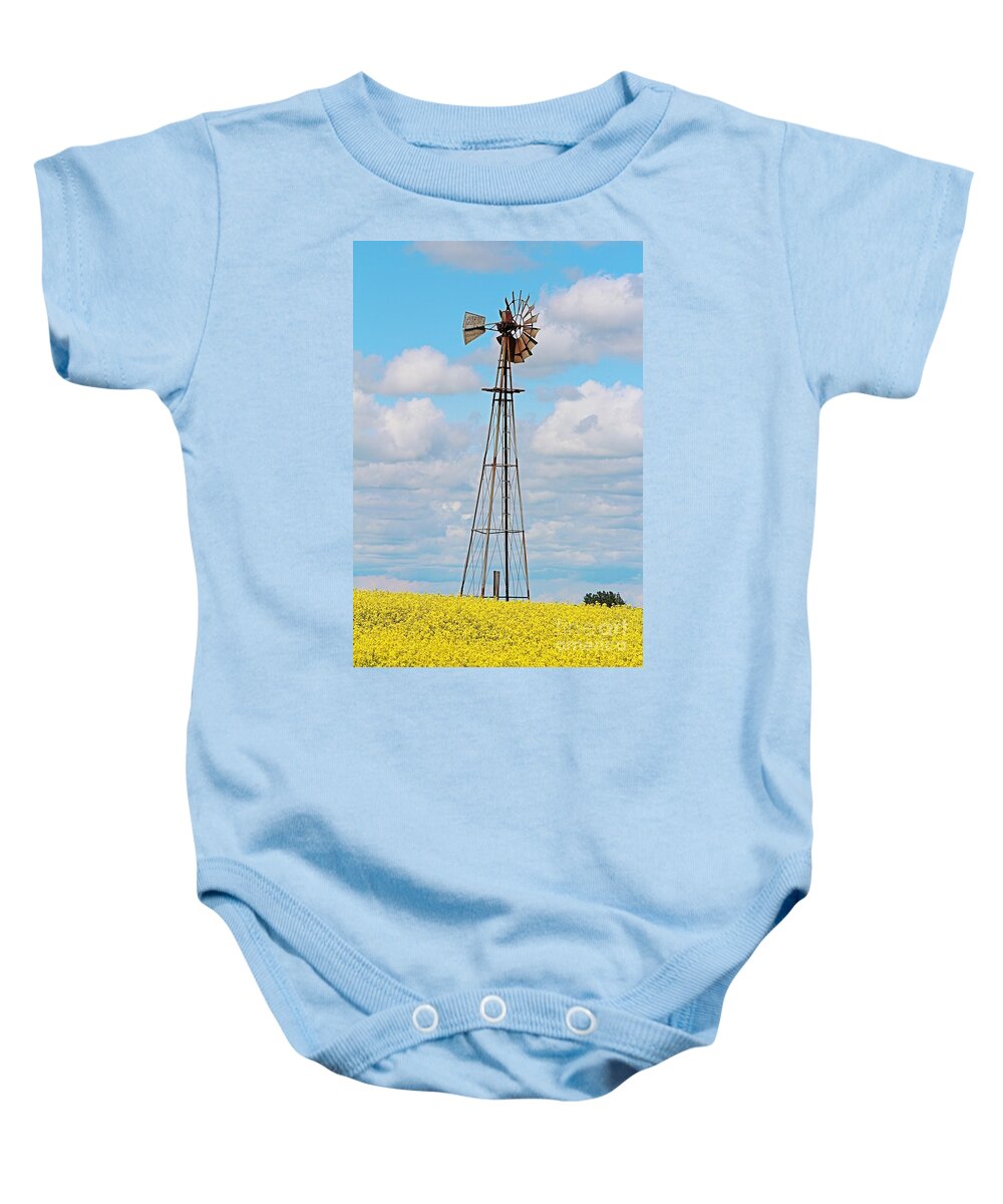 Windmill Baby Onesie featuring the photograph Windmill in Canola Field by Ann E Robson