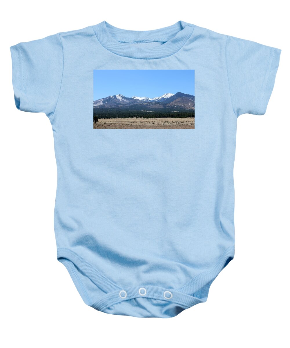 Sunset Crater National Monument Baby Onesie featuring the photograph San Francisco Peaks at Sunset Crater Volcano National Monument by Christy Pooschke