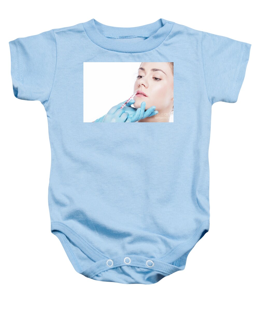 Aesthetic Baby Onesie featuring the photograph Young woman having lip-plumping injections. by Michal Bednarek
