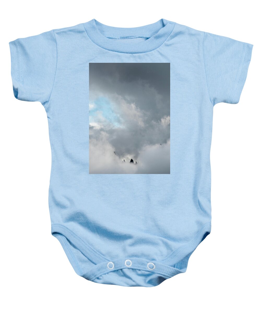 Italian Alps Baby Onesie featuring the photograph Cloudy landscape with edge of rocky mountains between the stormy sky by Michalakis Ppalis