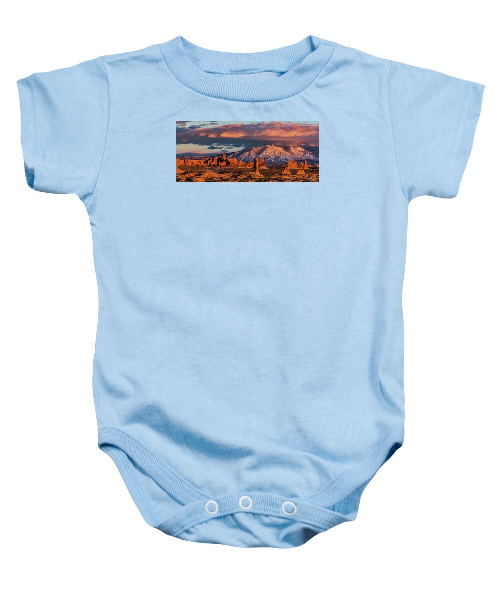 Arches National Park Moab Utah Sunset Red Rock Balanced Rock Hoodoos Towers Baby Onesie featuring the photograph North Window, La Sal Mountains and red rock towers by Dan Norris