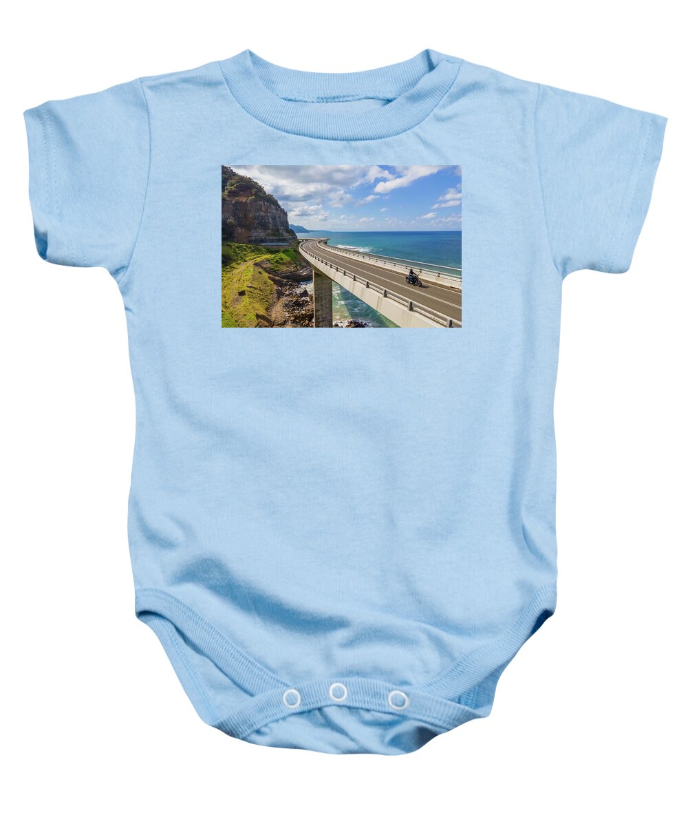 Bridge Baby Onesie featuring the photograph Sea Cliff Bridge and a Lone Biker by Andre Petrov