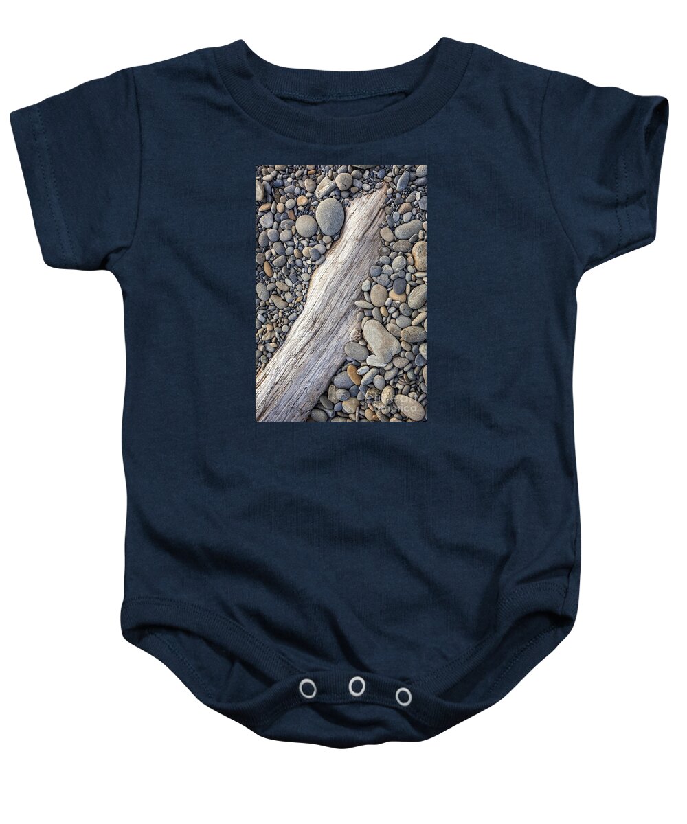 Driftwood Baby Onesie featuring the photograph Driftwood on Rock Covered Beach by Bryan Mullennix