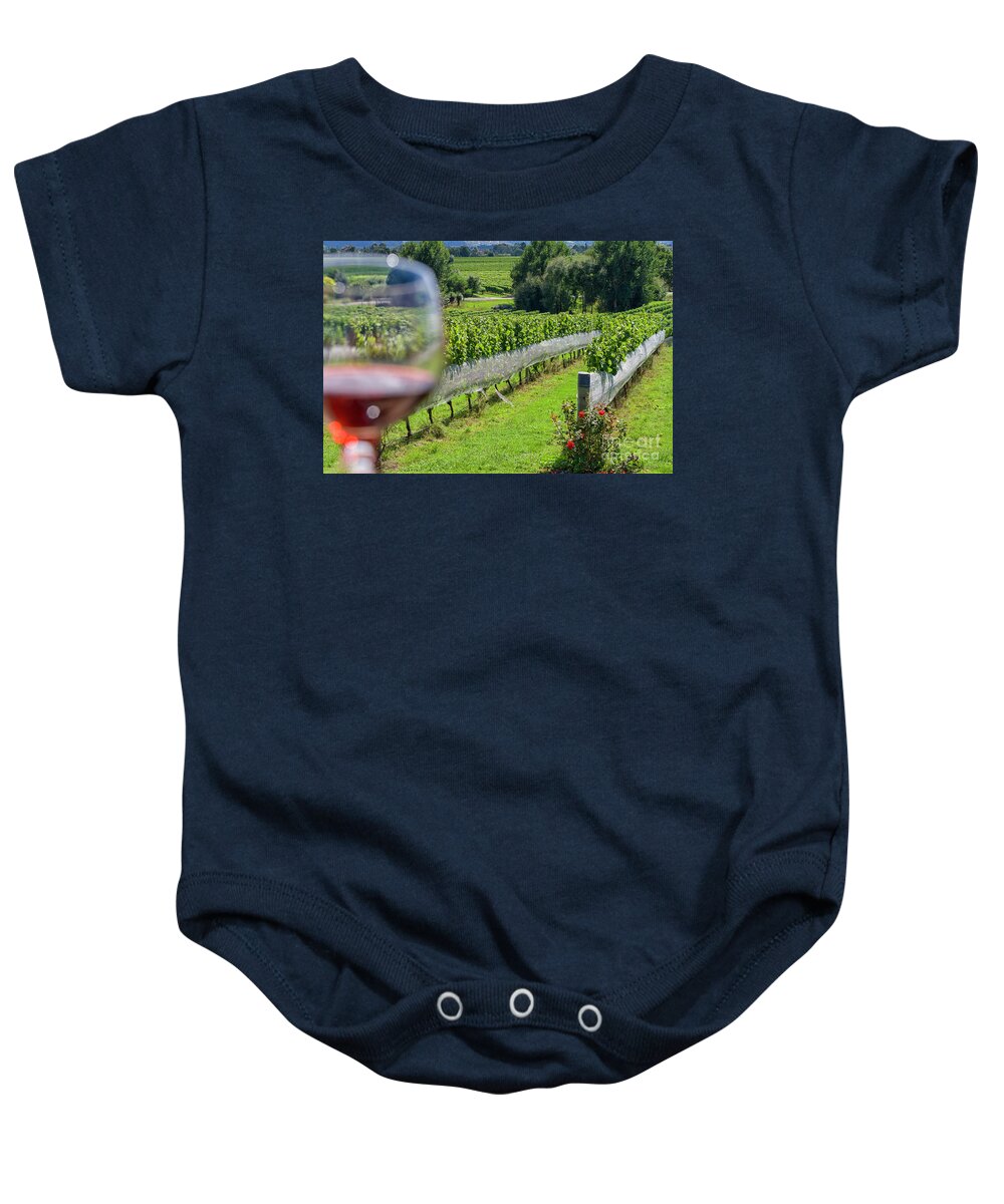 Wine Baby Onesie featuring the photograph Wineglass in vineyard by Patricia Hofmeester