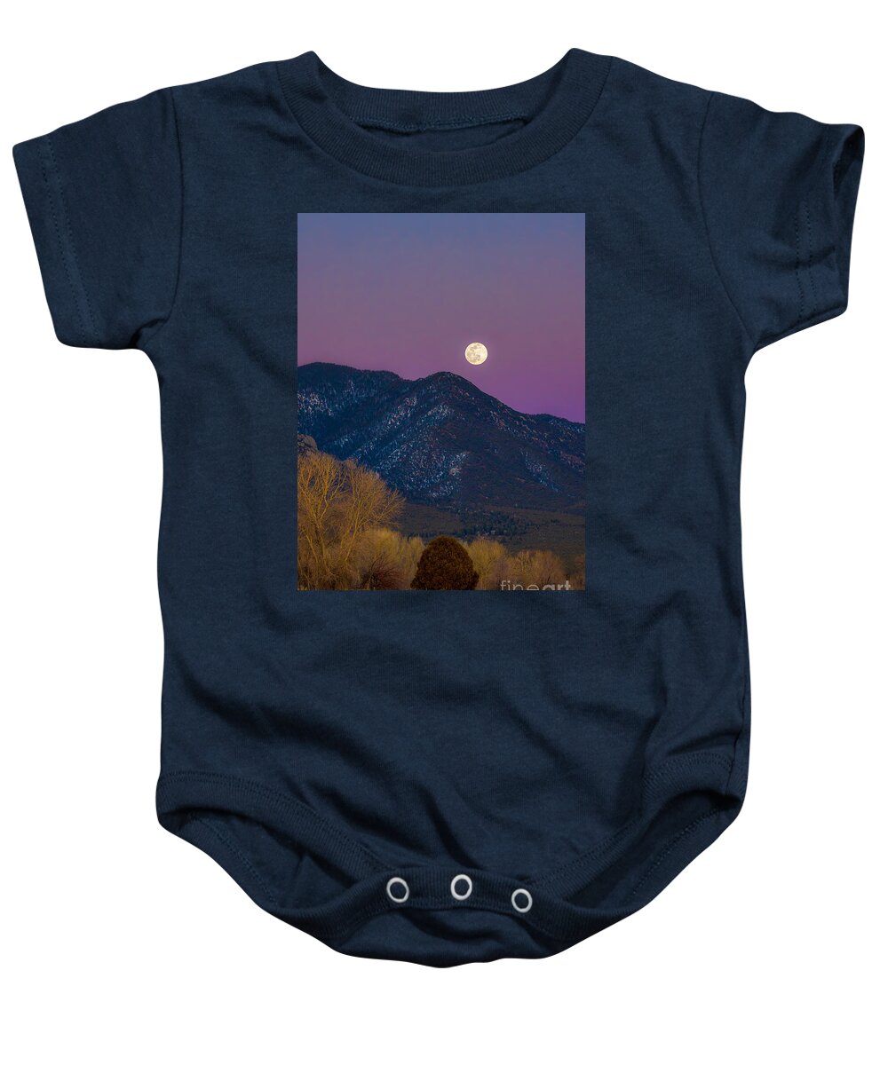Taos Baby Onesie featuring the photograph Snow Moon over Taos Mountain #1 by Elijah Rael