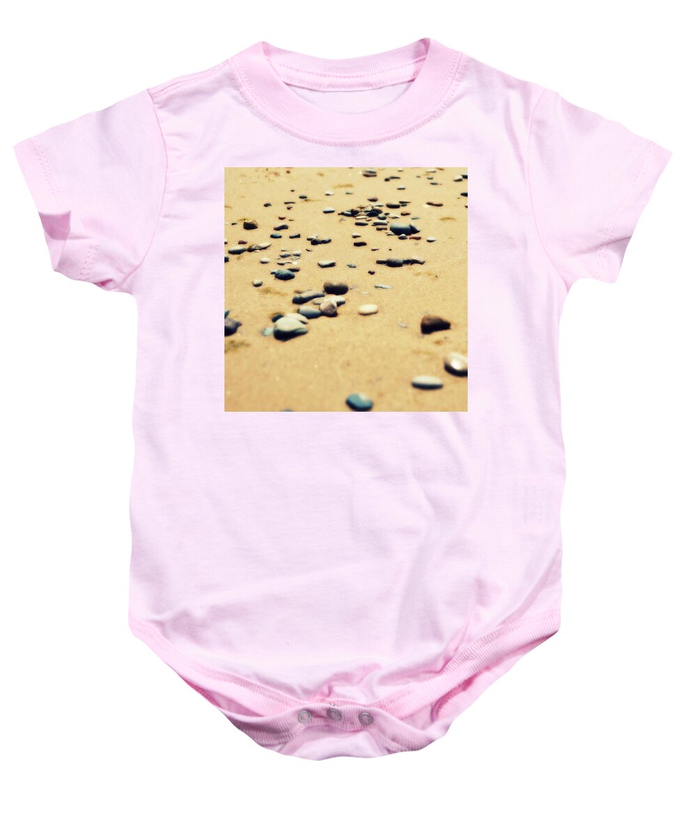 Nautical Baby Onesie featuring the photograph Pebbles on the Beach by Michelle Calkins