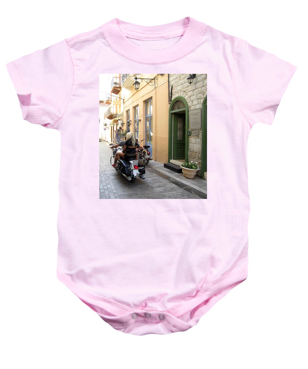 Motorcycle Baby Onesie featuring the photograph Girl Riding on Motorcycle with Handsome Bike Rider Speed Stone Paved Street in Nafplion Greece by John Shiron