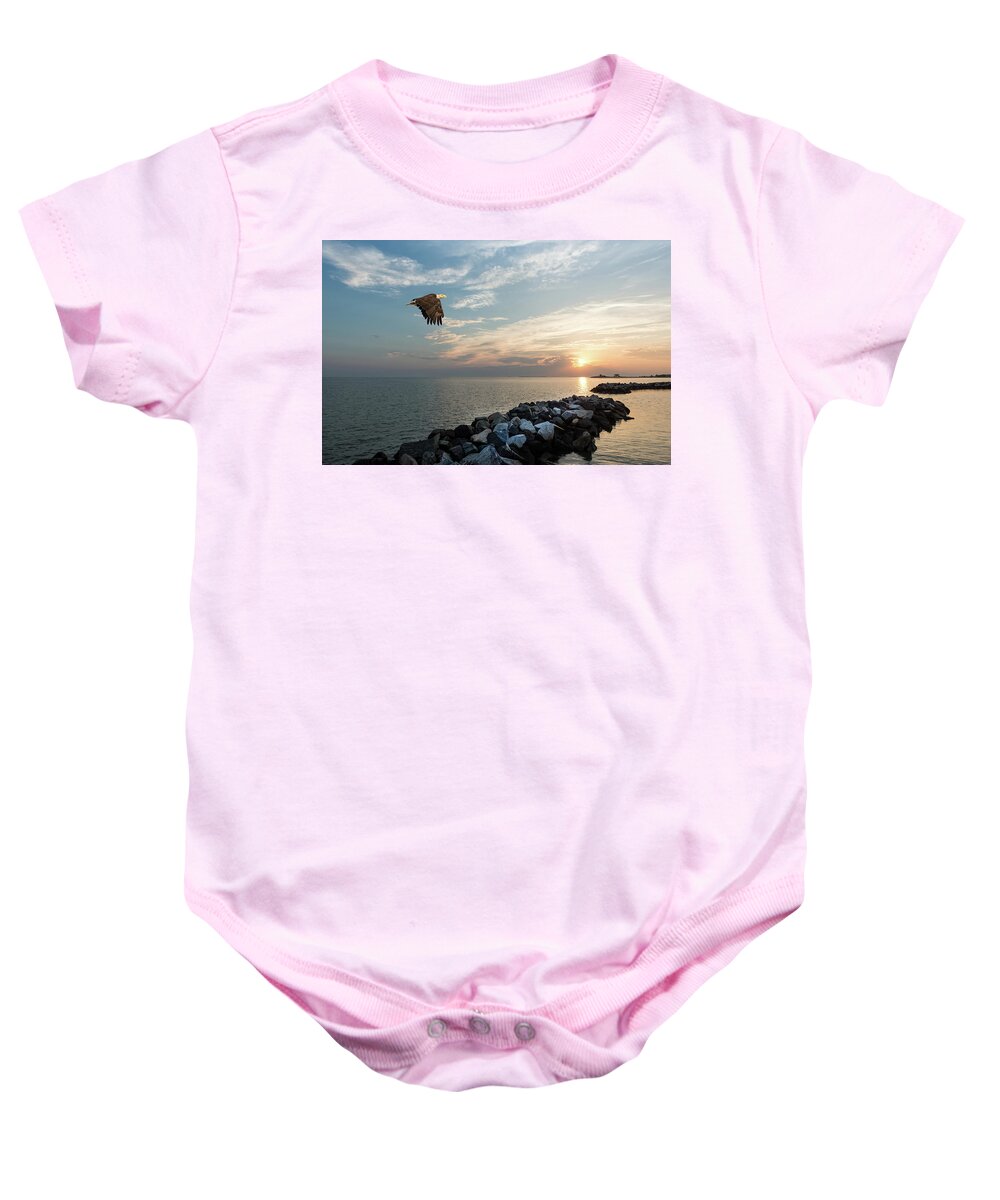 Bald Eagle Baby Onesie featuring the photograph Bald Eagle flying over a jetty at sunset by Patrick Wolf