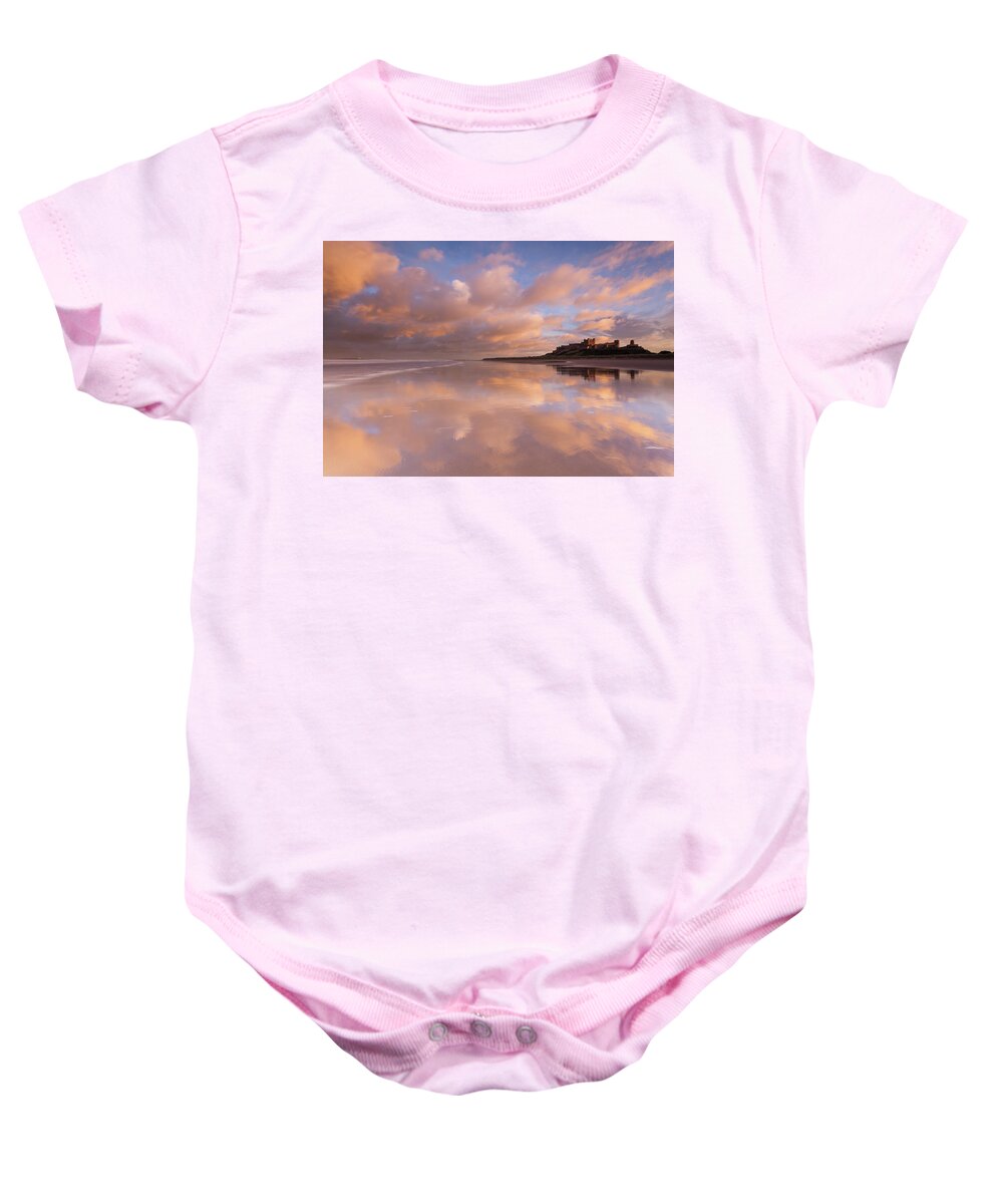 Bamburgh Castle Baby Onesie featuring the photograph Bamburgh Castle sunset reflections on the beach by Anita Nicholson