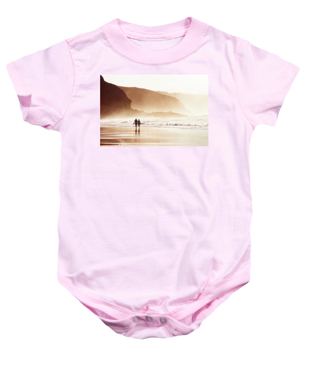 Couple Baby Onesie featuring the photograph Couple Walking On Beach With Fog by Mikel Martinez de Osaba