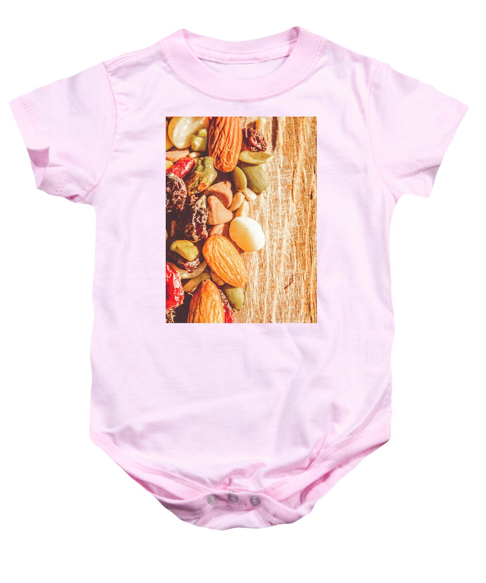 Nuts Baby Onesie featuring the photograph Mixed nuts on wooden background by Jorgo Photography