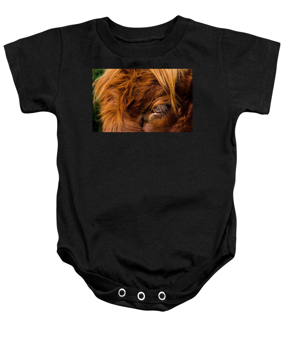 Eye Baby Onesie featuring the photograph Curious Glance Of A Highland Cattle by Andreas Berthold