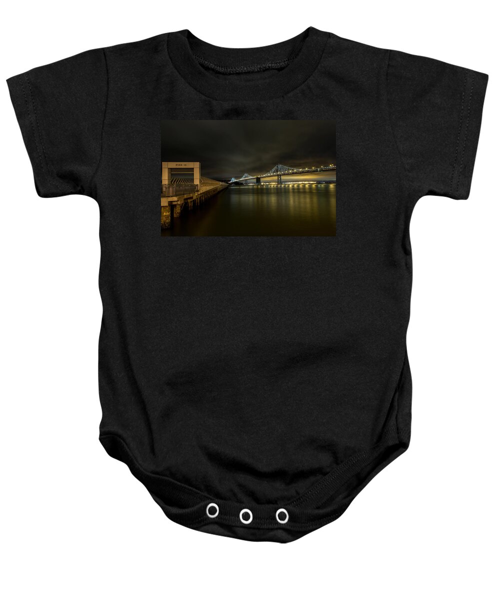 San Francisco Baby Onesie featuring the photograph Pier 14 and Bay Bridge at Night by John Daly