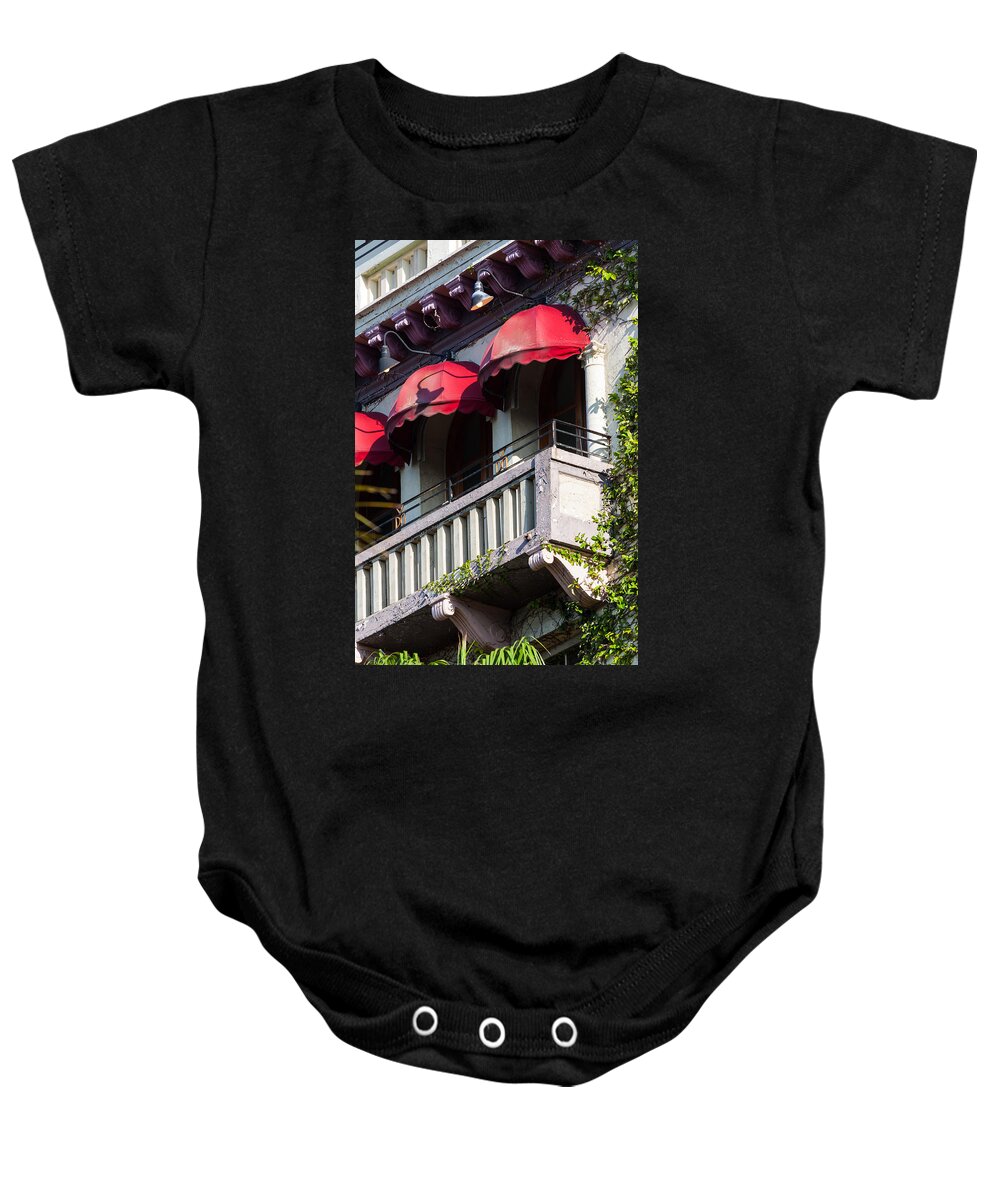1924 Baby Onesie featuring the photograph Red Awnings at the Van Dyke by Ed Gleichman