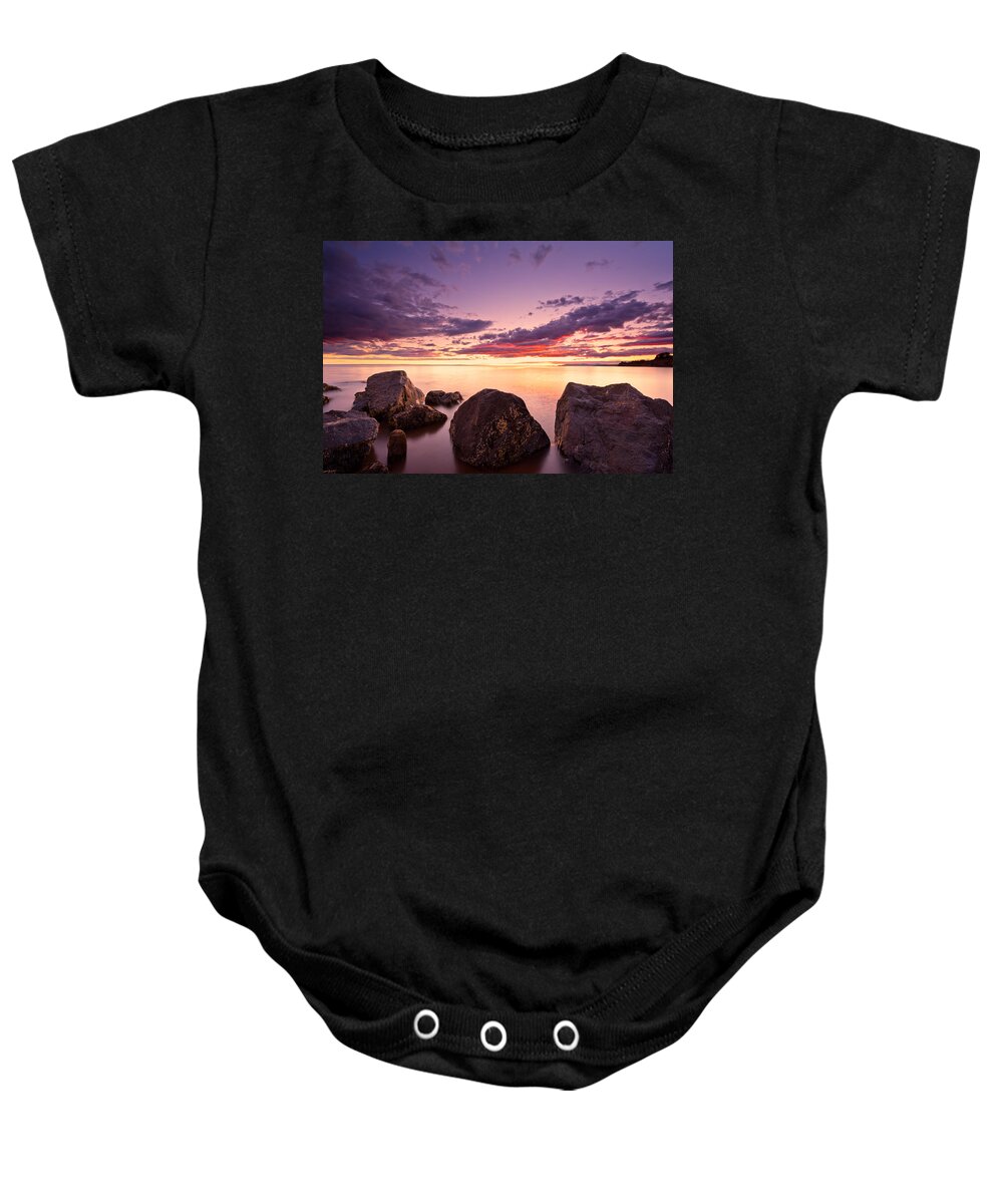 Beach Baby Onesie featuring the photograph Sea at sunset the sky is in beautiful dramatic color by U Schade