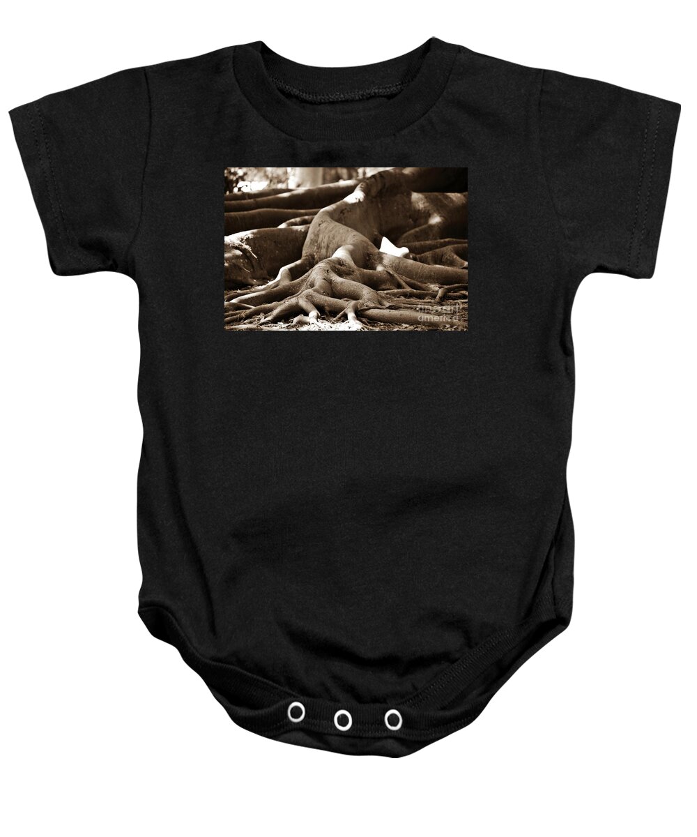 Roots Of Fig Tree Shot Low In Sepia. Baby Onesie featuring the photograph Fig Tree Roots #1 by Angela Murray