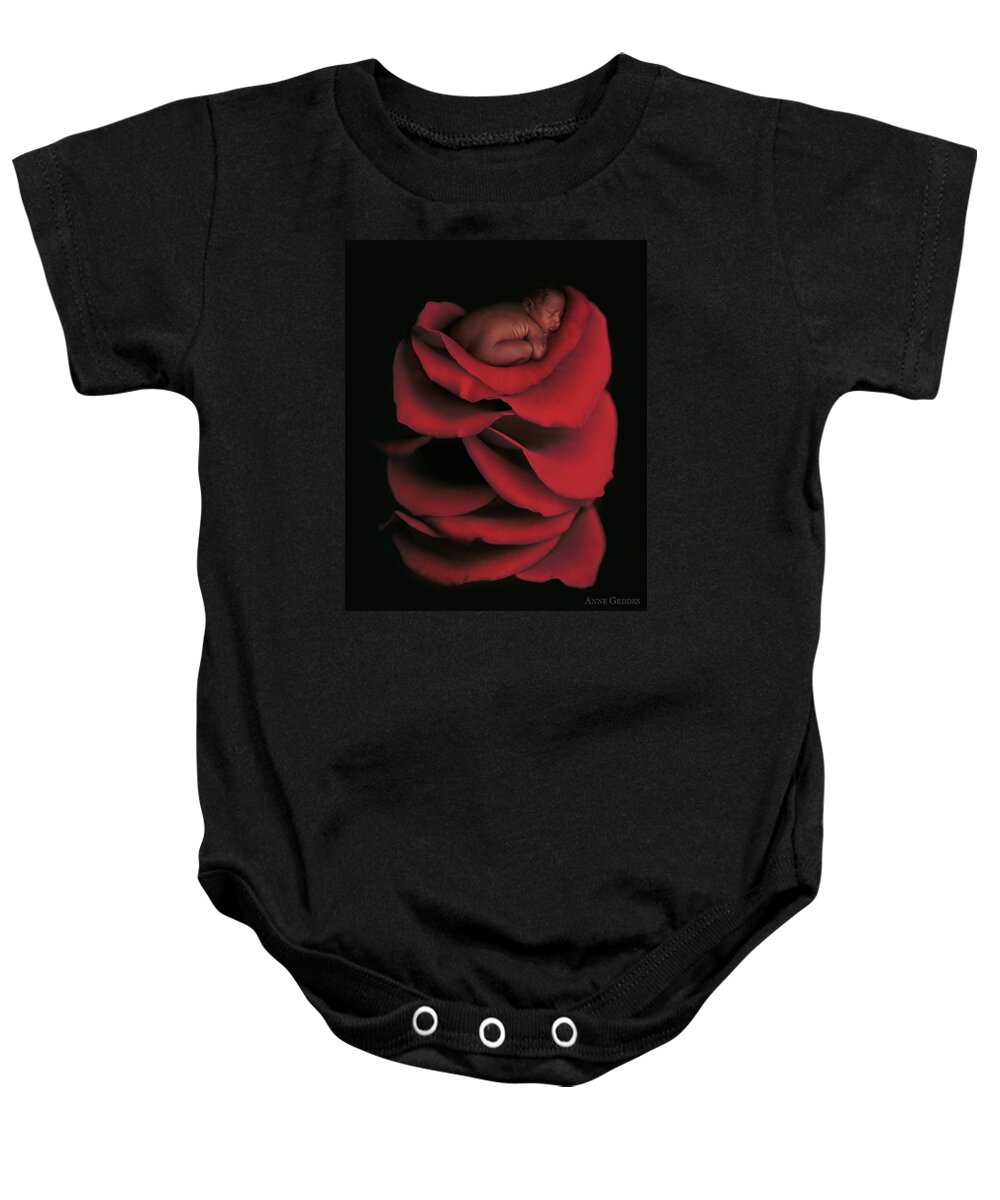 Rose Baby Onesie featuring the photograph Kwasi On A Bed Of Rose Petals by Anne Geddes