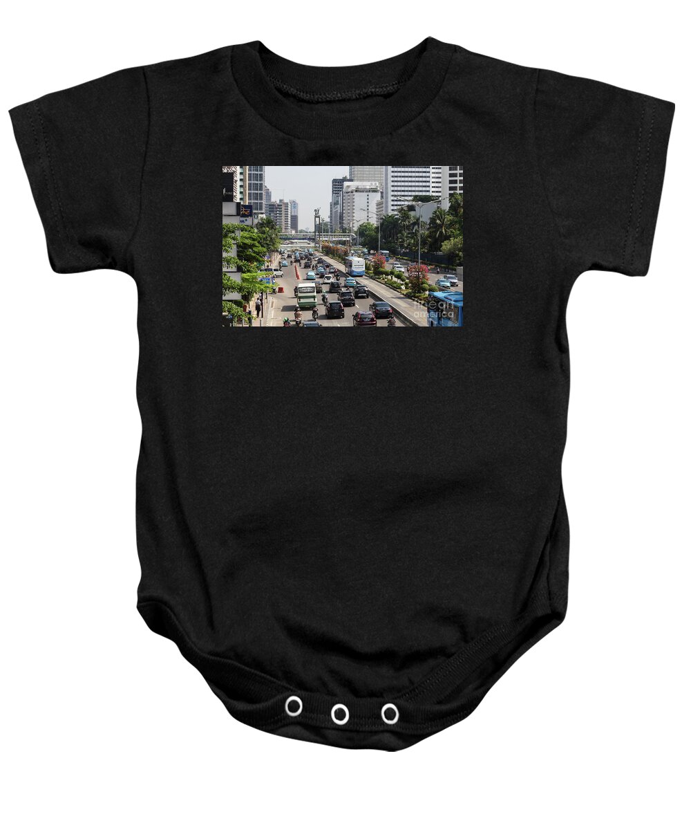 Capital Cities Baby Onesie featuring the photograph Traffic along Sudirman avenue in Jakarta, Indonesia capital city #4 by Didier Marti