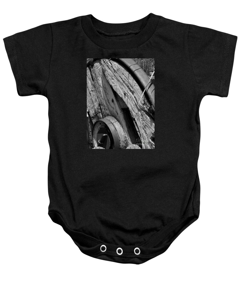 Black Baby Onesie featuring the photograph Black and white wagon wheel 1 by Christy Garavetto