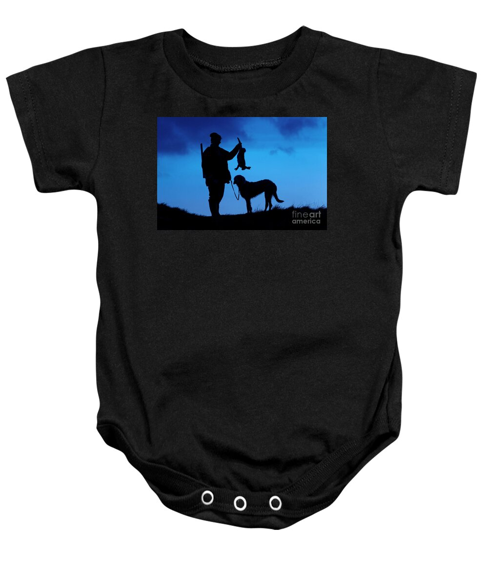 Hunter Baby Onesie featuring the photograph Hunter with Hare at Sunset by Arterra Picture Library