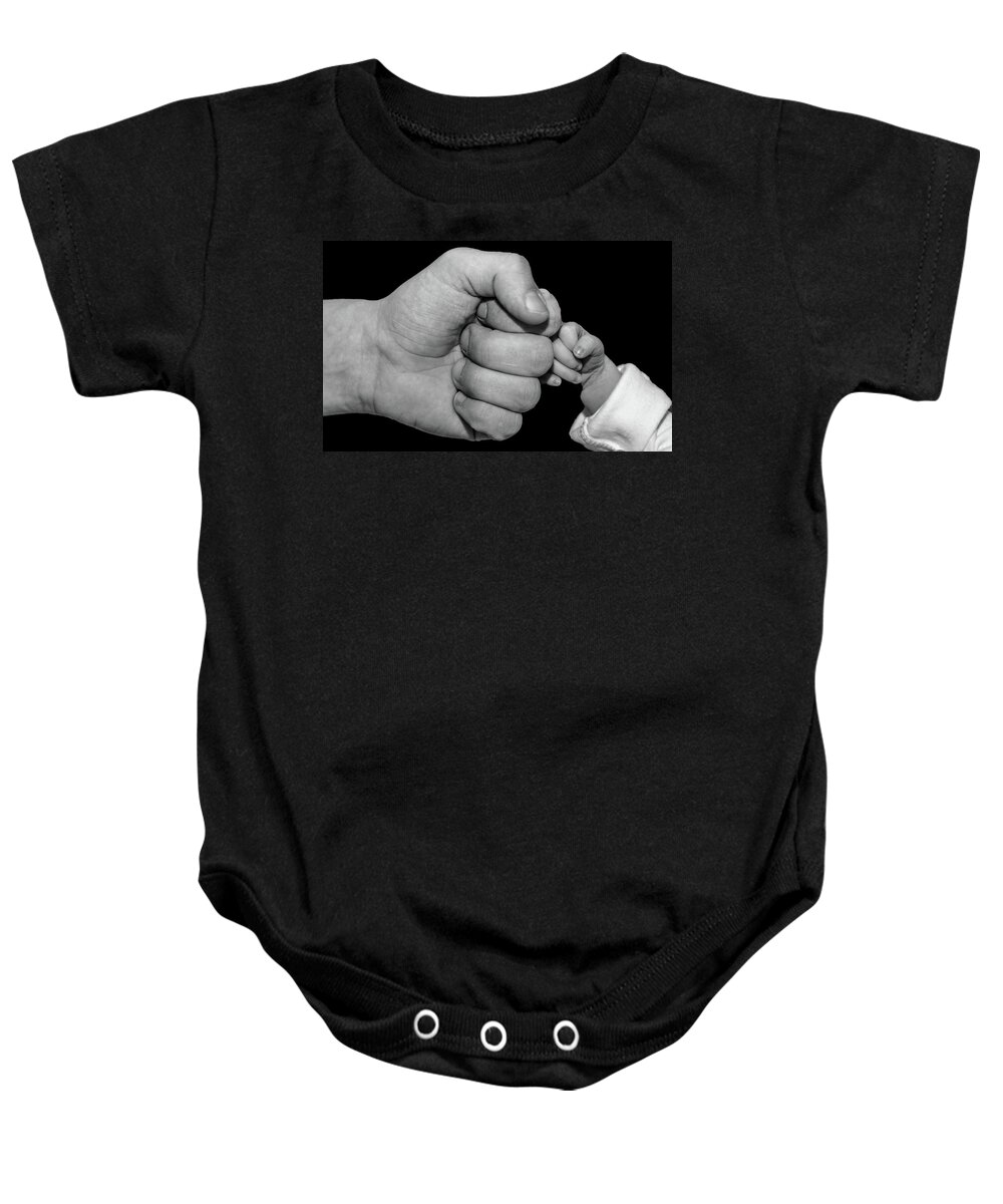New Born Baby Onesie featuring the photograph New born fist bump by Joe Holley