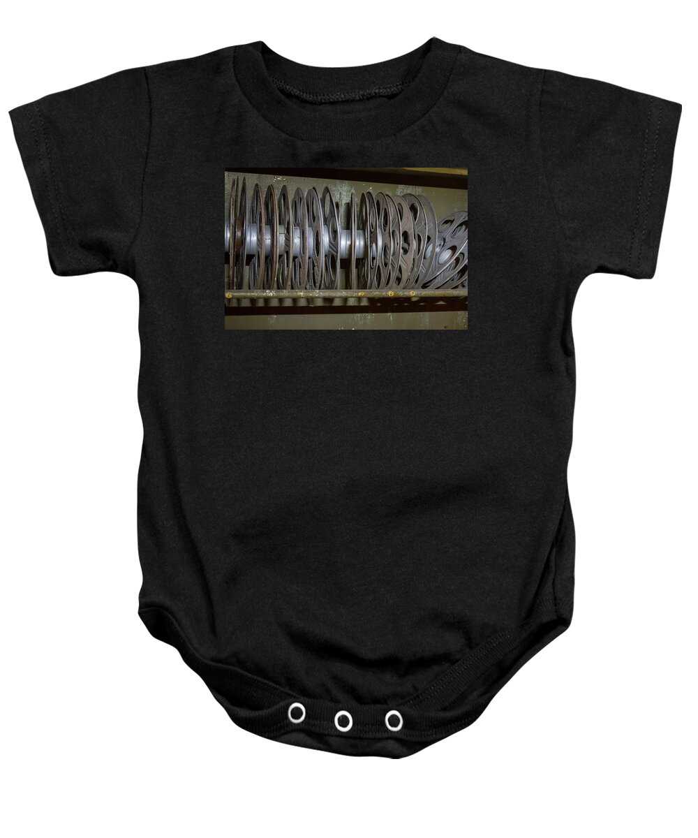 Antique Baby Onesie featuring the photograph Rack of vintage movie reels by Karen Foley