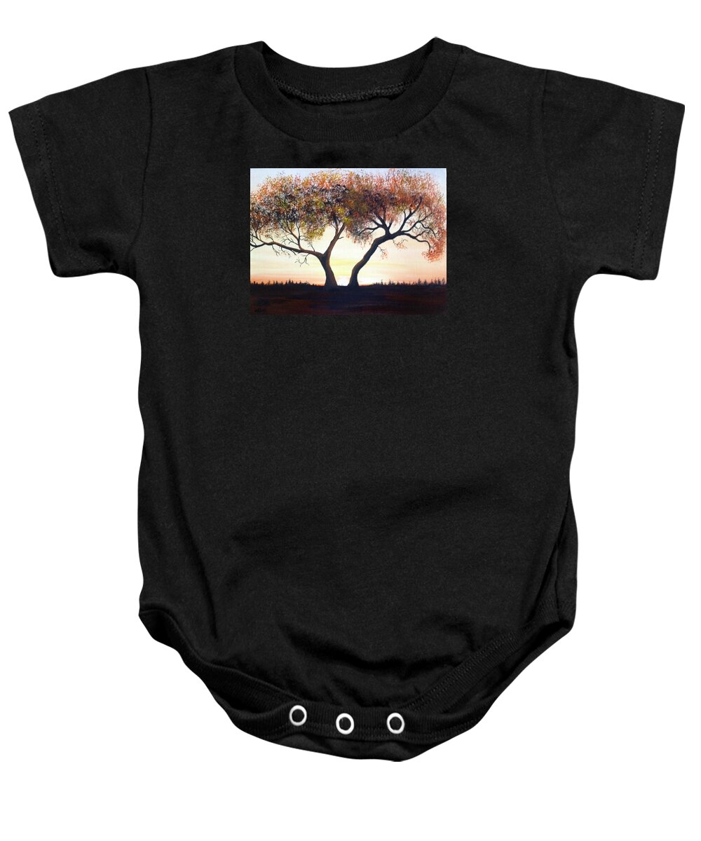 A One Hundred Year Old Tree In The Middle Of A Meadow. The Sun Is Coming Up In A Cloudless Sky With Distance Trees In The Background. The Tree Has Many Dead Branches And The Leaves Are Multiple-colored. Baby Onesie featuring the painting The Eli Tree by Martin Schmidt