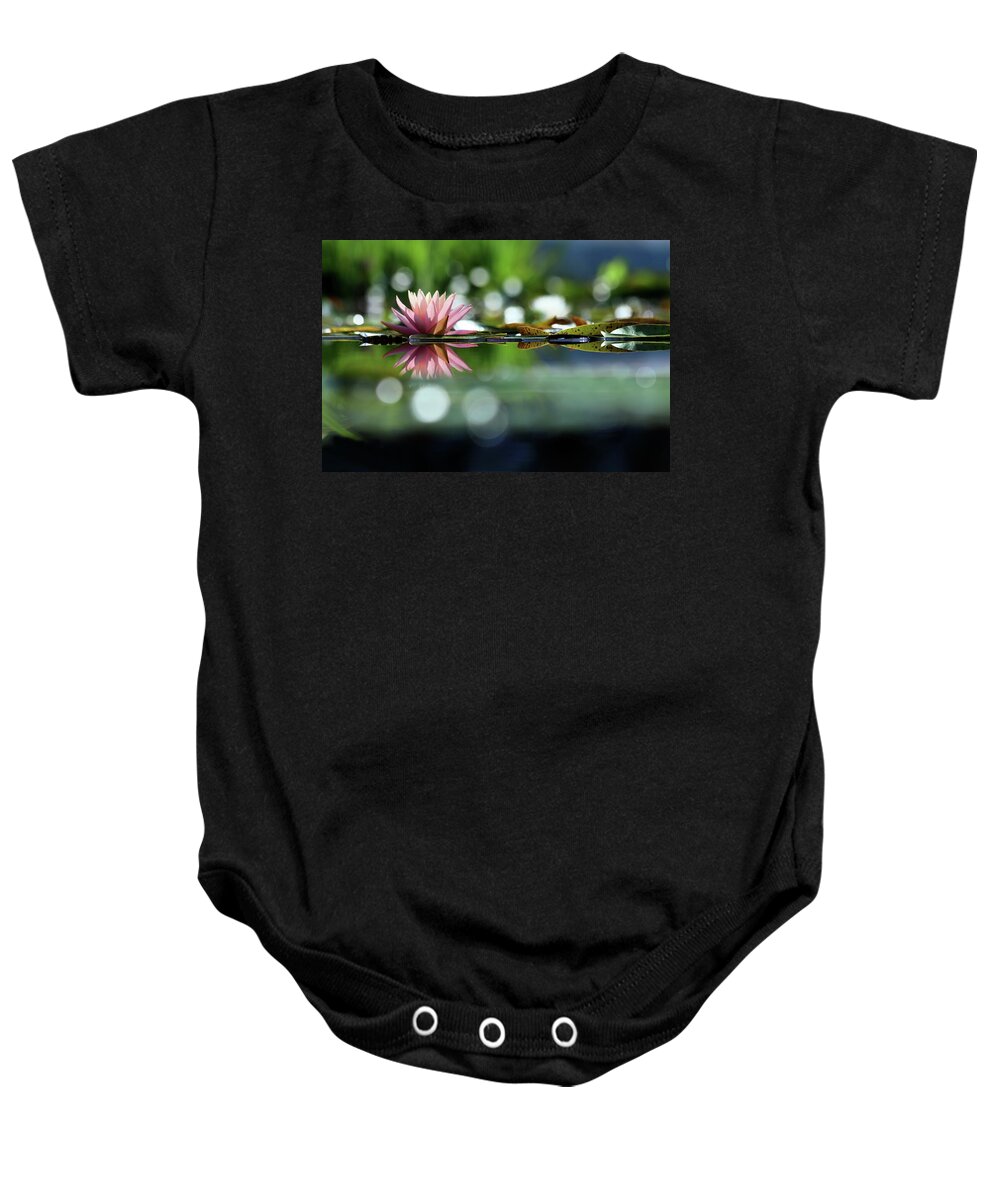  Soft Pink Water Lily Baby Onesie featuring the photograph Water Lily And Bokeh by Carol Montoya