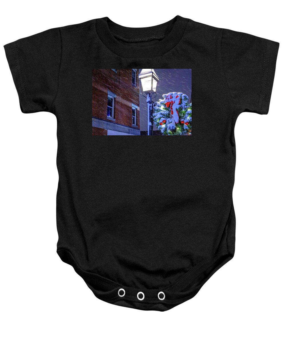 Blowing Snow Baby Onesie featuring the photograph Wreath On A Lamp Post by Jeff Sinon