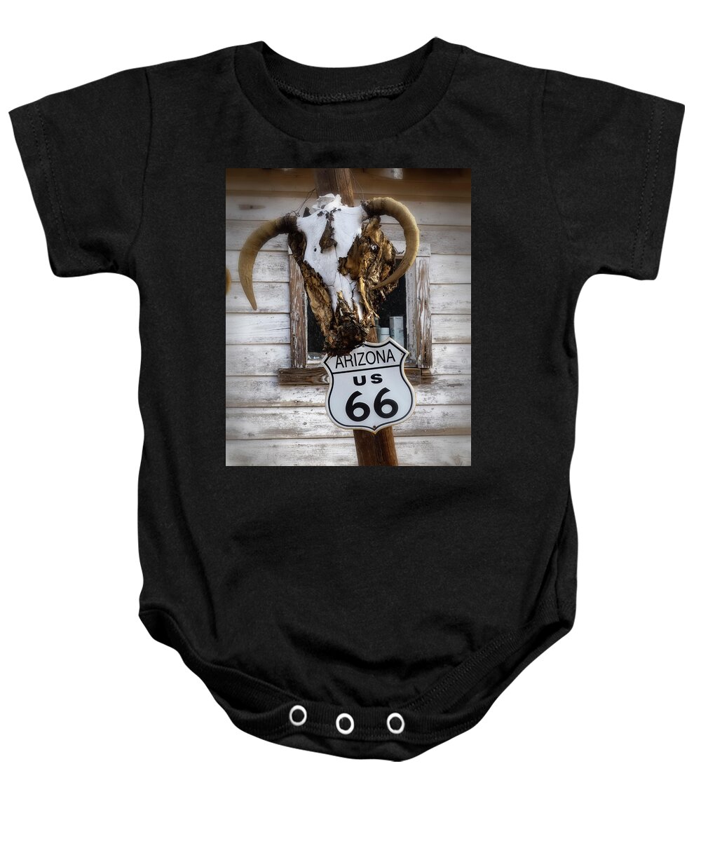 Hackberry Arizona Baby Onesie featuring the photograph cow skull and Route 66 sign by Gary Warnimont