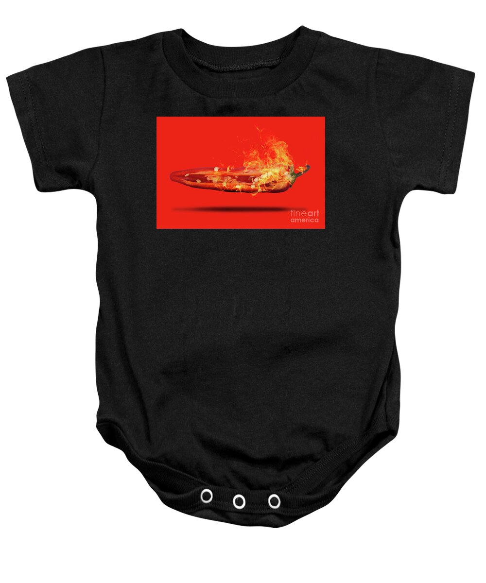 Red Baby Onesie featuring the photograph Half a red chili pepper on fire with seeds by Simon Bratt