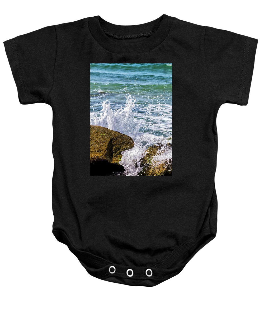 Wave Baby Onesie featuring the photograph Wave Break Against Rocks on Atlantic Beach by Bob Decker