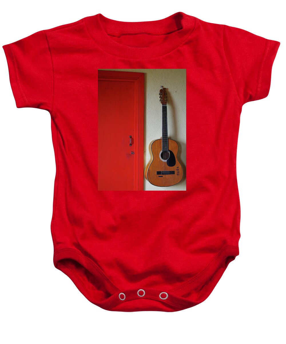 Guitar Baby Onesie featuring the photograph Guitar and Red Door by Adam Reinhart