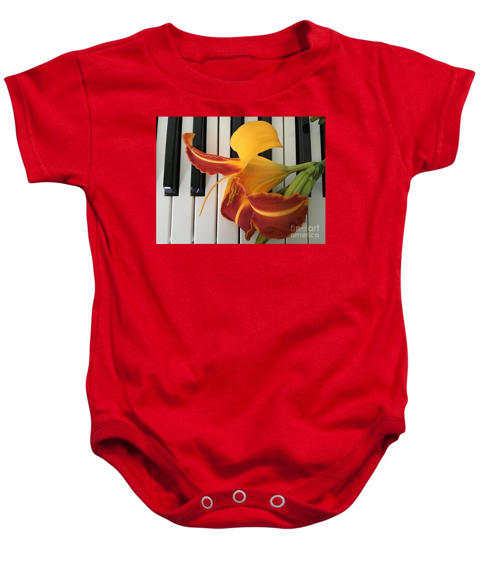 Lily Baby Onesie featuring the photograph Happy Lily on Keyboard by Catherine Wilson