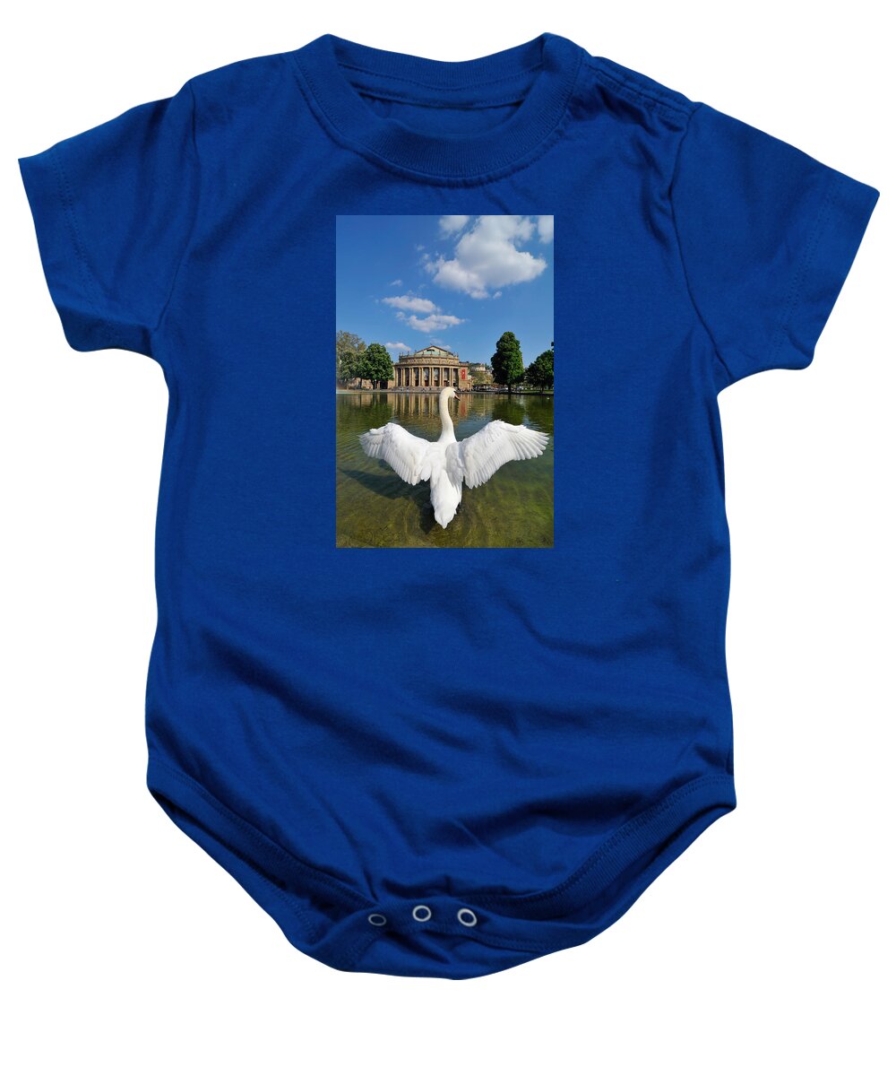 Swan Baby Onesie featuring the photograph Swan spreads wings in front of State Theatre Stuttgart Germany by Matthias Hauser
