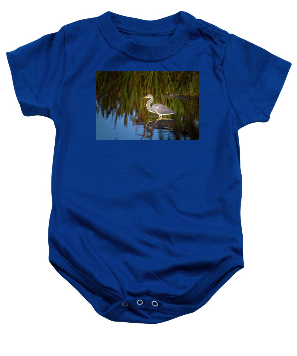 Tricolor Heron Baby Onesie featuring the photograph Tricolored Heron Enjoys the Sunset by Mark Andrew Thomas