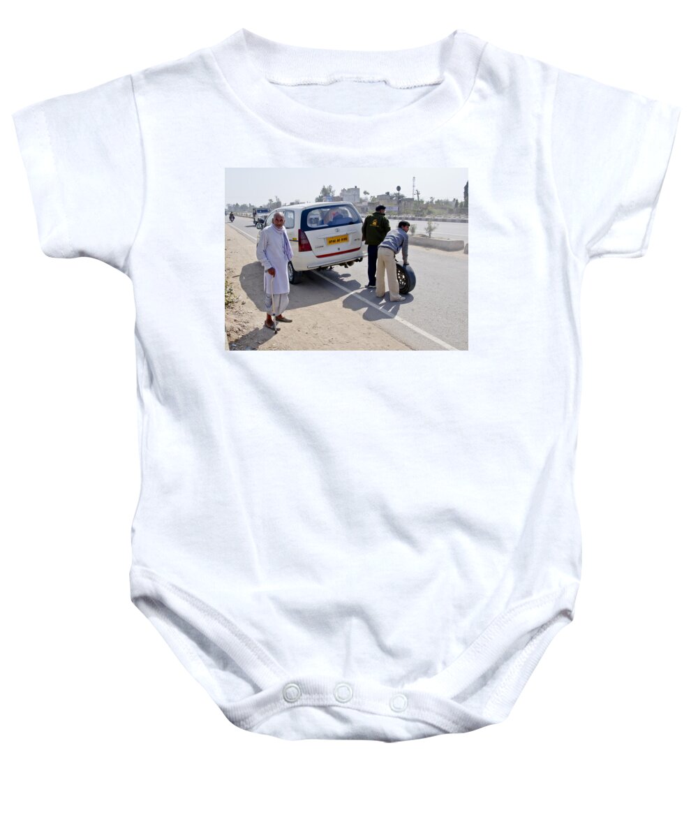 Village Baby Onesie featuring the photograph An old villager at the roadside. by Elena Perelman