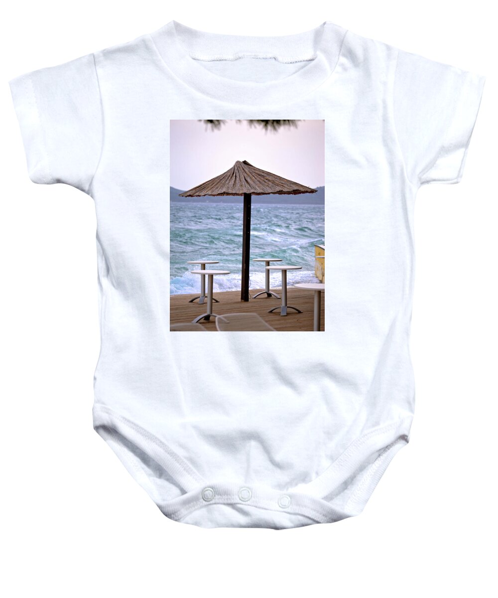 Beach Baby Onesie featuring the photograph Beach bar parasol by rough sea by Brch Photography